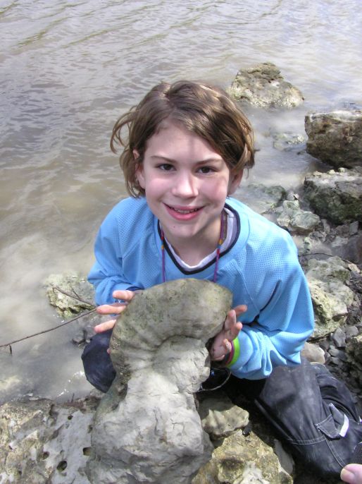 showing off fossil ammonite