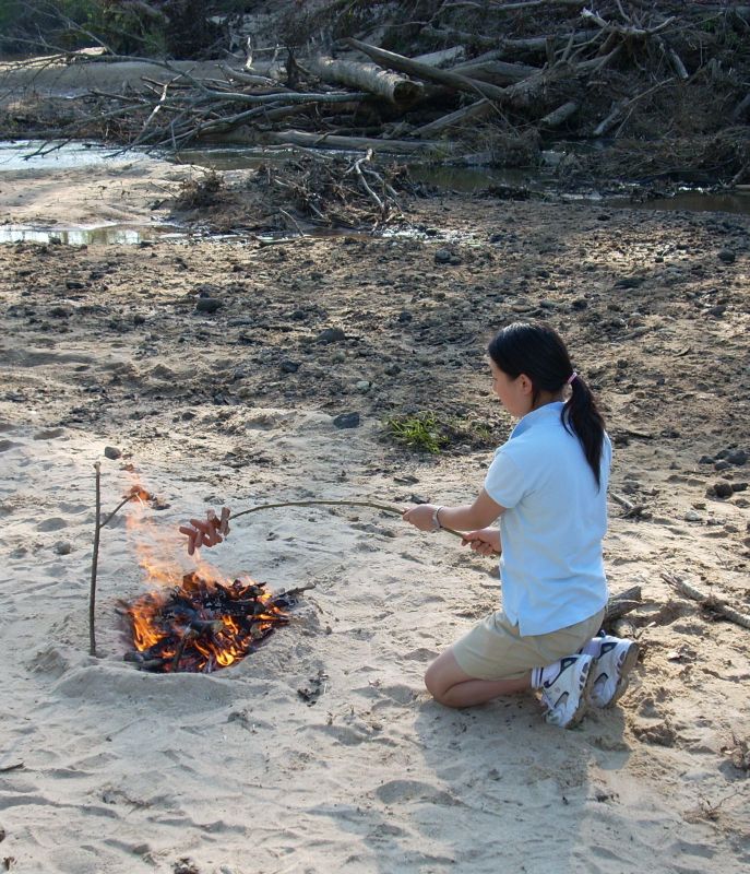 cooking on campfire by creek