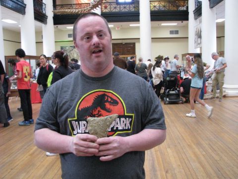 Exhibit attendee with his free fossil