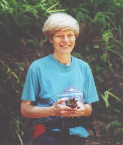 Vicki holding mosasaur vertebra