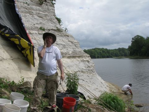 Hot, tired, and rain is coming, lets get all these full buckets of dirt and rock to the top of the bluff.