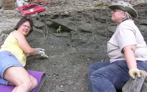 Martha and Becky on the Eotrachodon orientalis dinosaur dig, with our green mascot