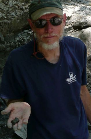 Bob showing the Eotrachodon orientalis dinosaur vertebra he found